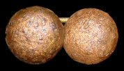 Plain domed copper alloy buttons with a copper alloy link. The alloys of the buttons and link appear to have different amounts of copper since the color is very different after chemical stripping.